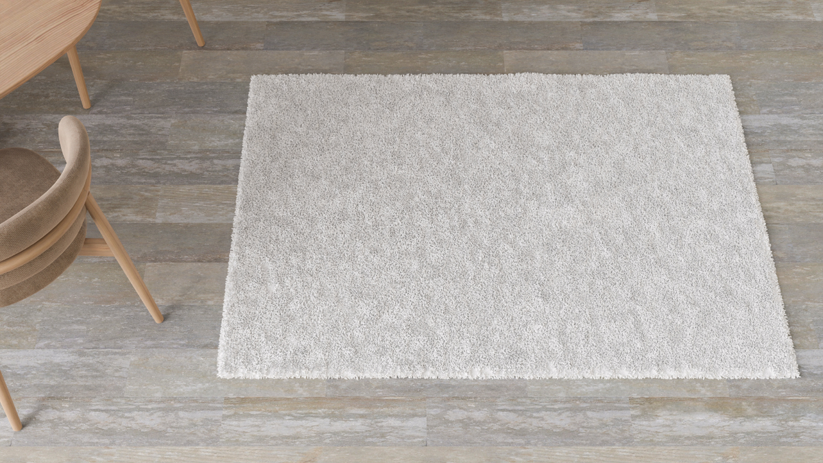 Square area rug in a small seating nook