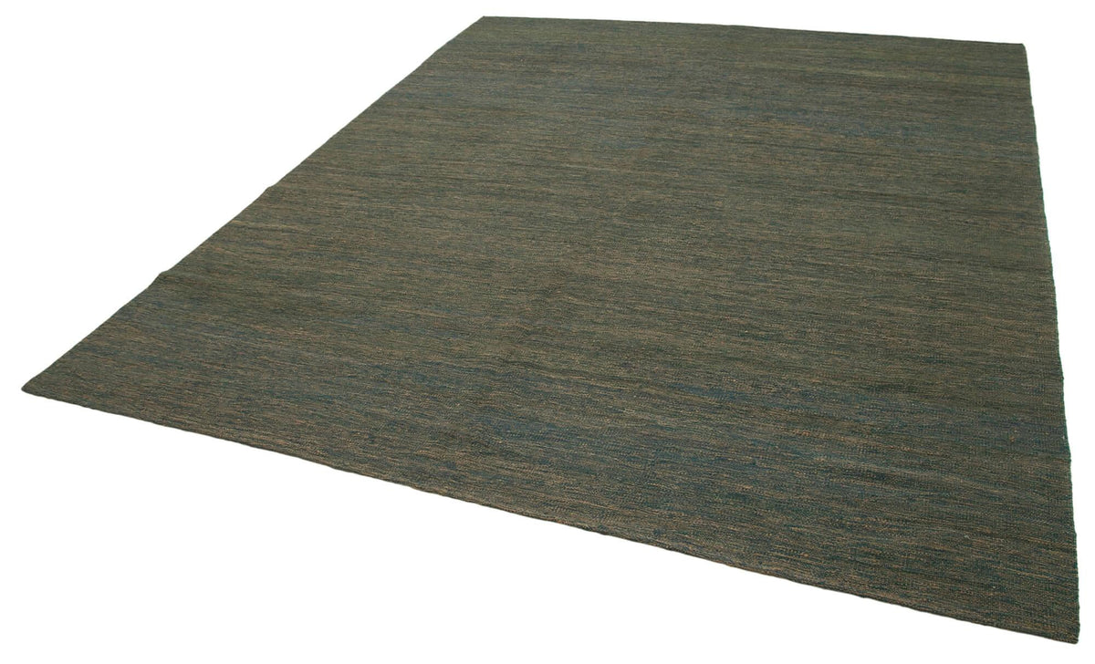 Green modern kilim rug paired with neutral furniture