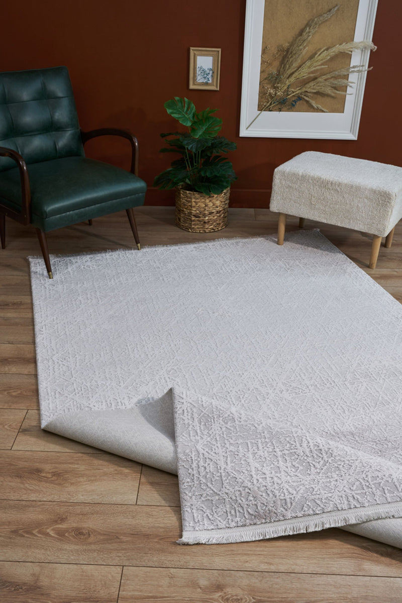 Cream modern acrylic machine-made area rug styled in a living room.