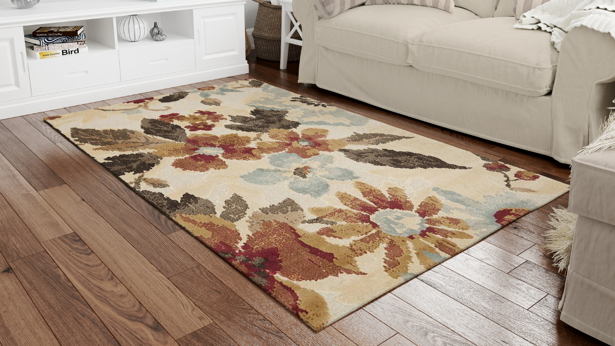 A vibrant floral-pattern area rug in a bright living room, illustrating how to wash and care for floral rugs