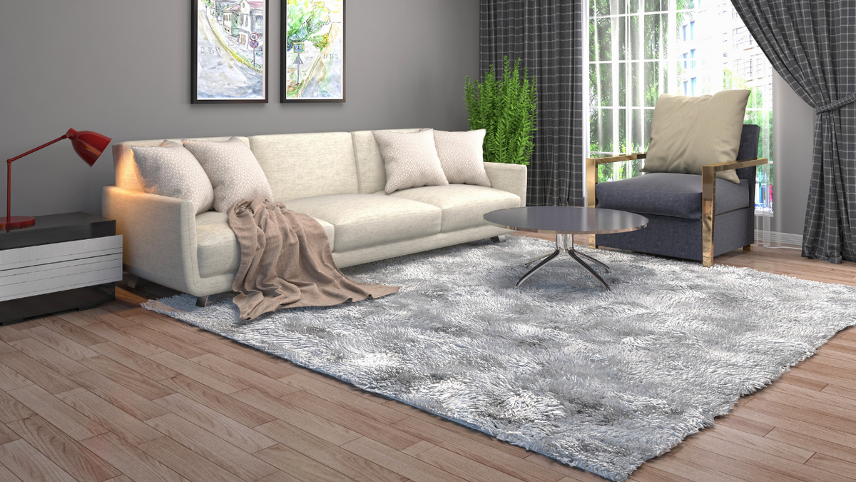 Fitted rug cover being smoothed over a patterned area rug